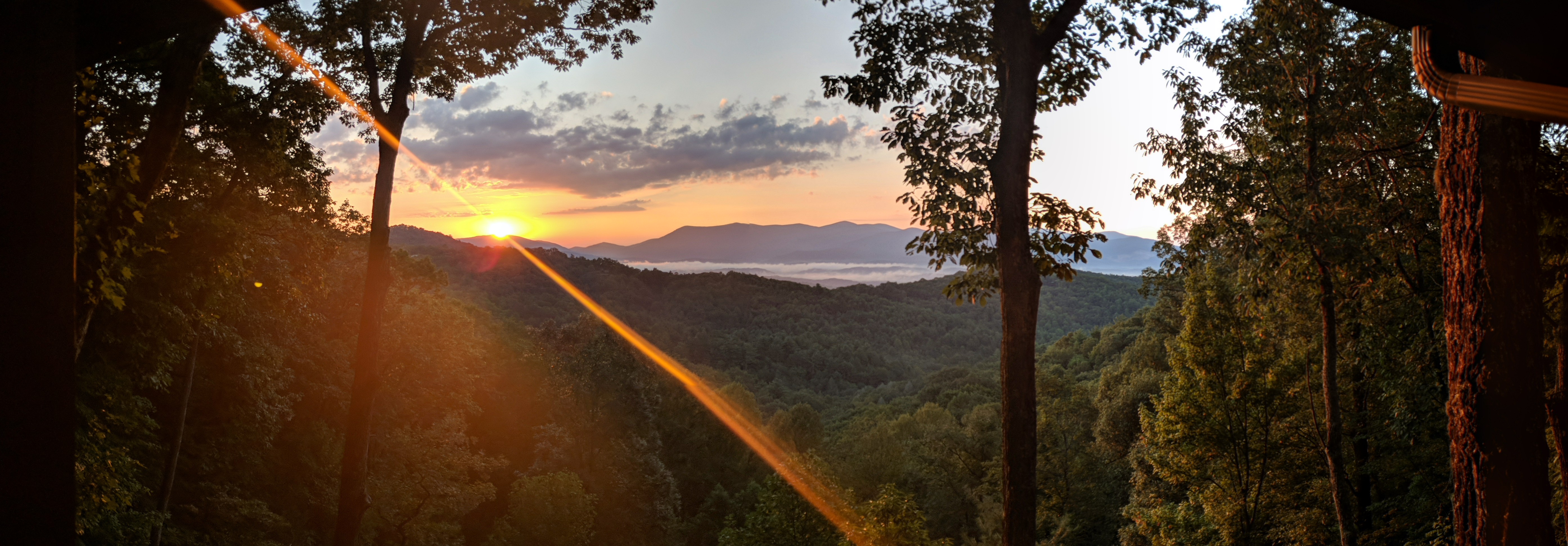 The kind of sunrise that makes coffee taste better — long-range mountain views from Moose Mountain Lodge.